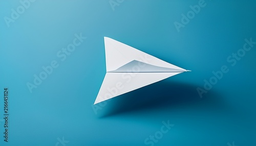 minimalist white paper airplane soaring through a clear blue studio background symbolizing freedom communication and new ideas
