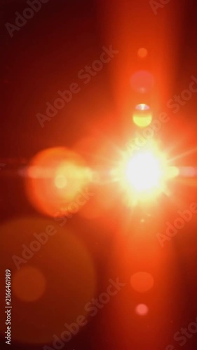 Warm orange lens flare and dreamy light leaks moving across a dark background for overlay