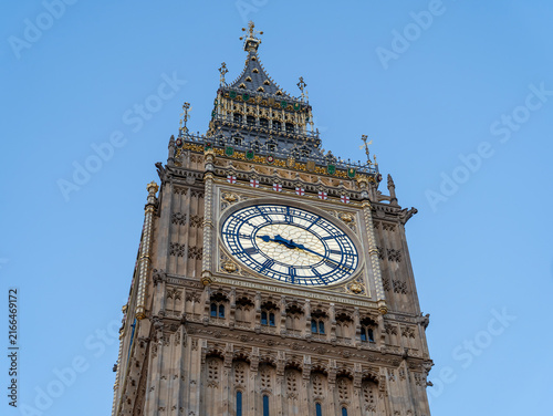 Detailed low angle view of Big Ben clock face and Elizabeth Tower in London UK