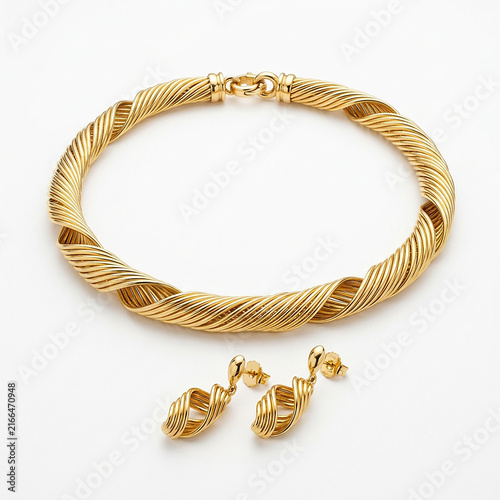 Luxury gold twisted rope bangle bracelet with matching spiral drop earrings on white background