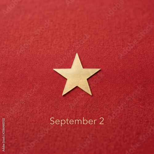 Golden star on red textured background for September 2 Vietnam National Day photo