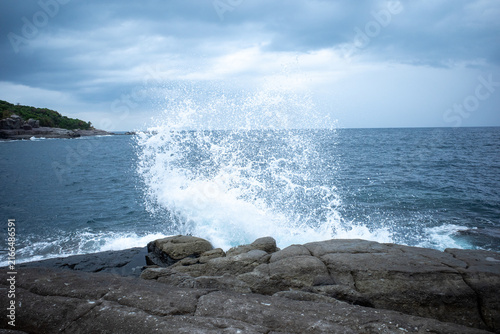 Ocean Wave Crashing Against Rocky Coast In Japan