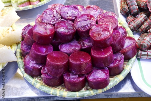 Obraz na płótnie Vibrant purple yam cake, Banh Khoai Mon, stacked on a tray, showcasing traditional Vietnamese dessert culture
