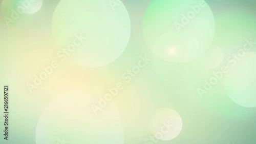 Soft pastel green and yellow bokeh background with light circular shapes for elegant design