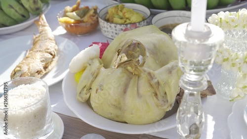 view to Altar table full with food, dessert, fruits, coconut and flower in Thai Style cultural in new home building ceremony in morning sunny time