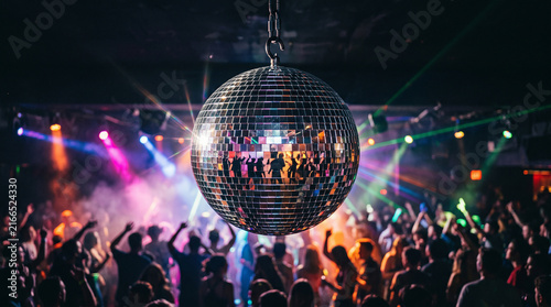 Ultra realistic close-up of a mirrored disco ball reflecting a crowded dance floor, silhouettes of young adults dancing under colorful beams of light 