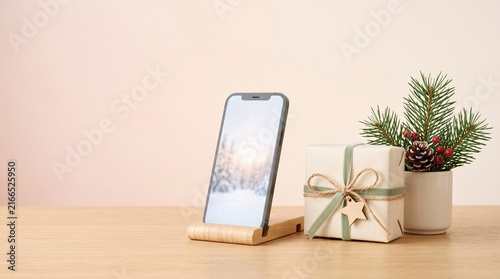 Modern smartphone displaying festive gift app next to wrapped Christmas presents on wooden table