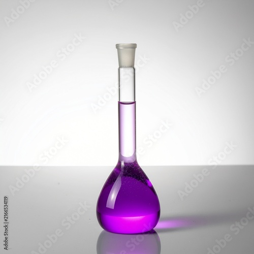 Volumetric flask with purple liquid for chemistry research