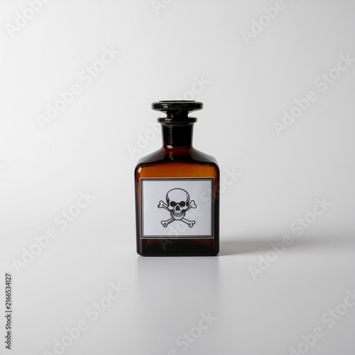 Vintage amber glass poison bottle with skull and crossbones