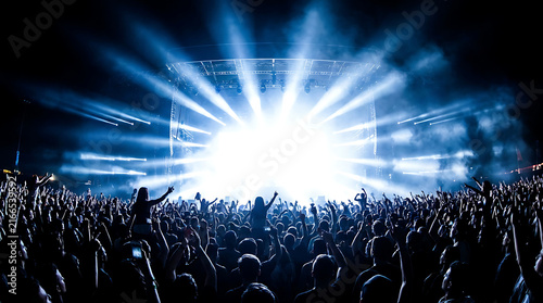 Crowd celebrating with bright light beams illustration