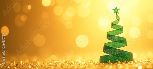 Christmas tree made of green ribbon on a yellow, shiny background.
