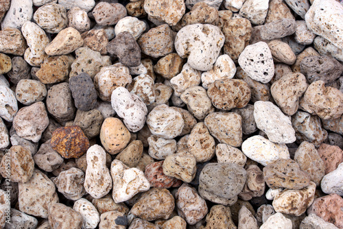 Background Pile of volcanic pumice rock stones is wet from cleaning isolated on white background. lightweight porous lava rocks for plant soil drainage gardening and aquarium filtration.