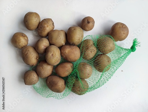 Fresh raw potatoes arranged on a clean white background, showcasing natural organic vegetables, healthy food ingredients, and rustic farm produce.