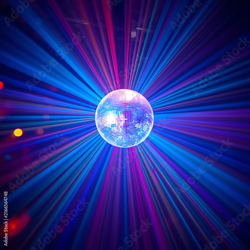 A colorful disco ball on stage with lights shining