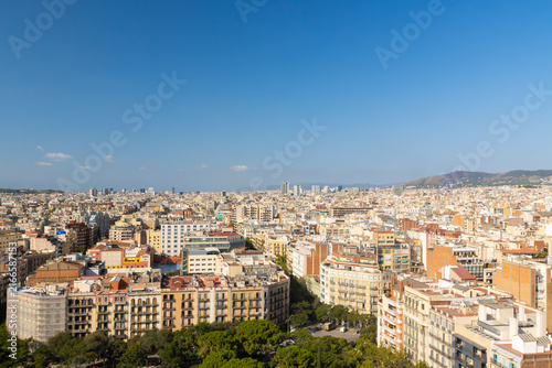 Panoramic Aerial View of Barcelona Cityscape with Montjuic Hill and Clear Blue Sky, Spain