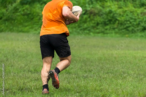 Photography Running with holding rugby ball on grass play ground