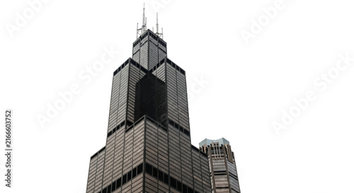 Low angle view of a dark iconic skyscraper reaching towards a clear white sky representing modern urban architectural design and city skylines