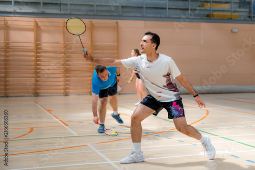 Badminton player compete in indoor tournament match