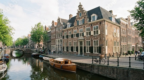 Amsterdam canal houses, boats, and bridge in historic district