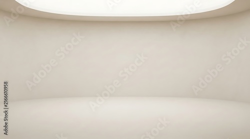 An empty, minimalist room with smooth, curved beige walls and a bright overhead light, creating a seamless, modern studio-like interior.