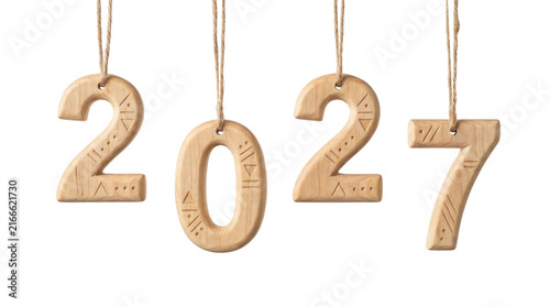 Wooden carved Scandinavian Christmas ornaments, numbers 2027, decorated with carvings hanging on threads, on a transparent background.