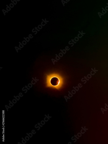 Solar eclipse with glowing corona in dark space