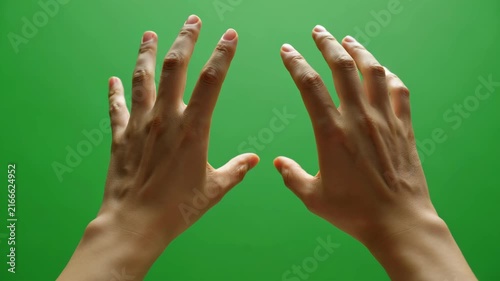 Close-up of Two Hands Performing Gestures on a Green Screen Background