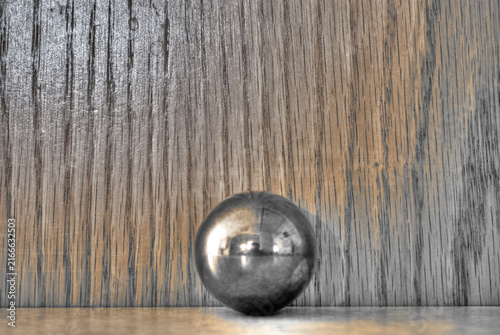 Photography Steel reflective ball with wooden background