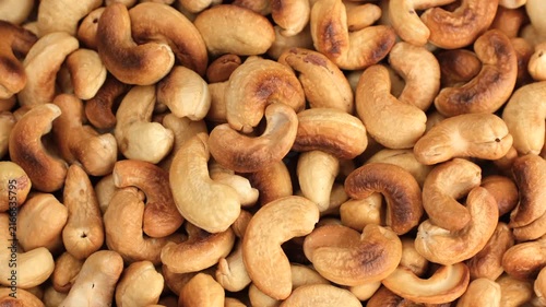 Zoom frame fresh roasted cashews close up, rotation
