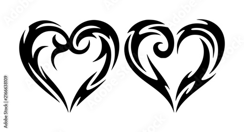 Two black tribal heart with intricate swirling patterns isolated on a plain white background for tattoos