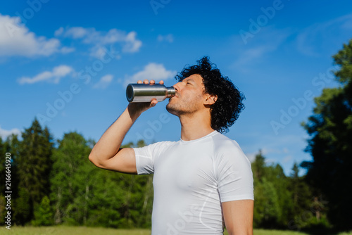 Runner Hydrating In Nature