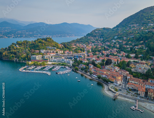Aerial drone view of Porto Laveno marina in Laveno-Mombello town on the shores of Lake Maggiore in Italy, with picturesque lakeside scenery and Alpine mountains