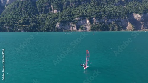 White Sailing Yachts Gliding Across a Scenic Swiss Lake