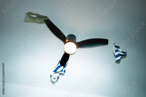 swimwear flying off a spinning ceiling fan indoors