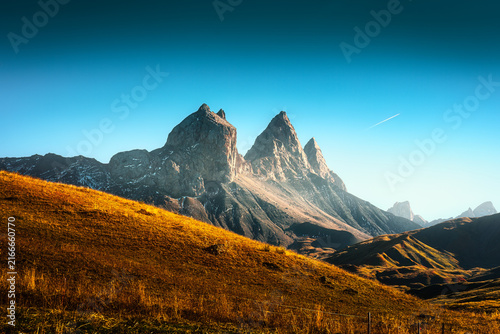Famous Rocky Three Peaks with Golden Hill and Blue Sky in French Alps France
