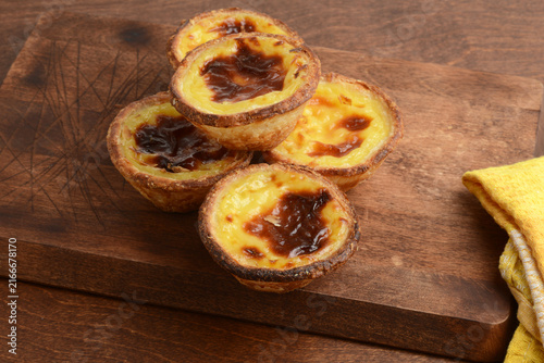 closeup pile of Portuguese Custard Tarts Pasteis de Nata on cutting board