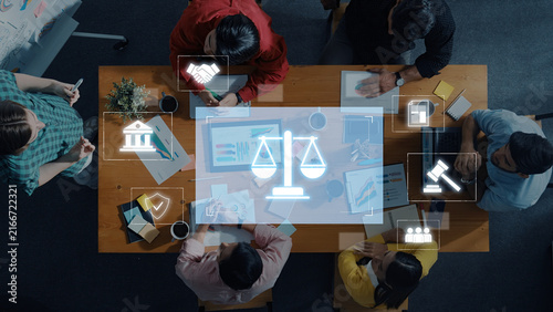 Canvas Print Top view of a meeting with diverse professionals discussing legal concepts, showcasing digital icons symbolizing justice and collaboration at a conference table