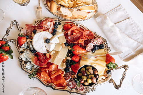 Canvas Print Elegant Charcuterie Board With Cheese, Cured Meats, Olives and Fresh Strawberrie