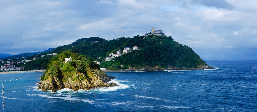 Fototapeta premium Santa Clara Island and Mount Igueldo Overlooking La Concha Bay in San Sebastian, Basque Country, Spain