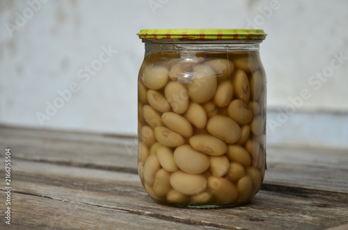 Glass Jar of Canned Beans on Rustic Wooden Table, Homemade Preserved White Beans, Vintage Pantry Food Storage Background