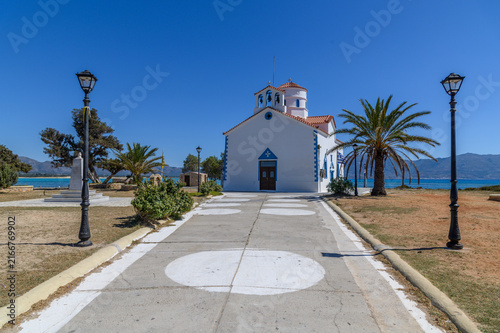 Paved walkway leading to the Church of Agios Spyridon between the sea on both sides, Elafonisos, Greece