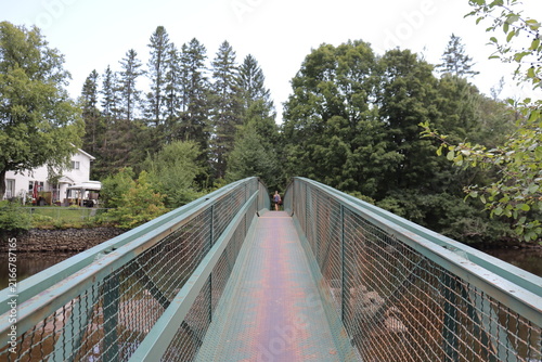 Metal bridge over the river. Installation for trail and foothpath or  gateway in metal.
