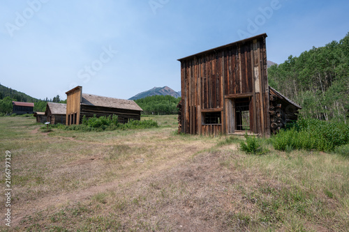 Long abandoned buildings of Ashcroft Ghost Town in Castle Creek Valley near Aspen, Colorado on sunny summer morning.