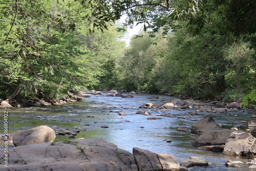 Panorama of a picturesque landscape in summer and the St-Charles river in Wendake in Quebec city. Beautiful stream of the river with trees and waterfalls. Protection of the water and environment.