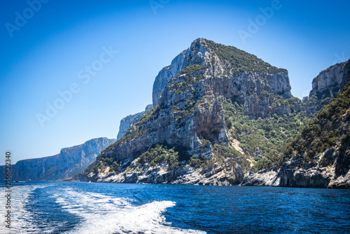 limestone cliffs and turquoise water, coast of baunei, gulf of orosei, sardinia, sardegna, italy, boats, mediterranean sea, vacation