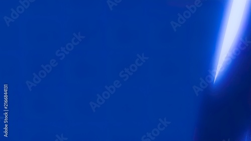 Vibrant blue laser beam cutting through dark space with glowing energy particles and futuristic light effects
