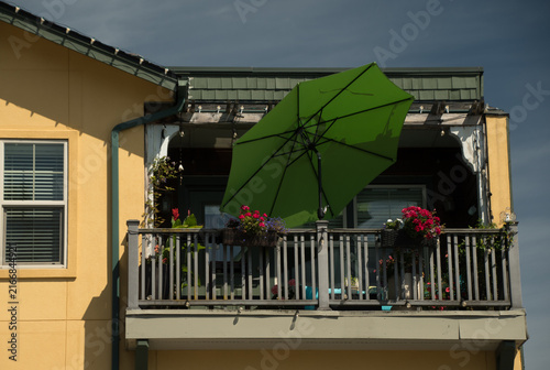 Bright Green Patio Umbrella on Colorful Historic Downtown Balcony