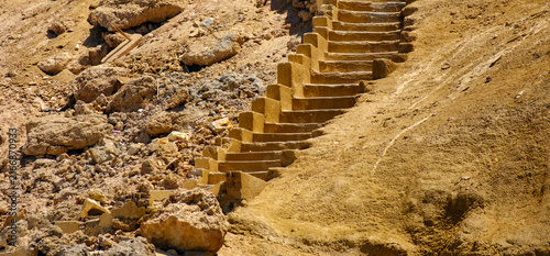 Canvastavla Stone steps carved into a dry desert hill surrounded by rocky terrain