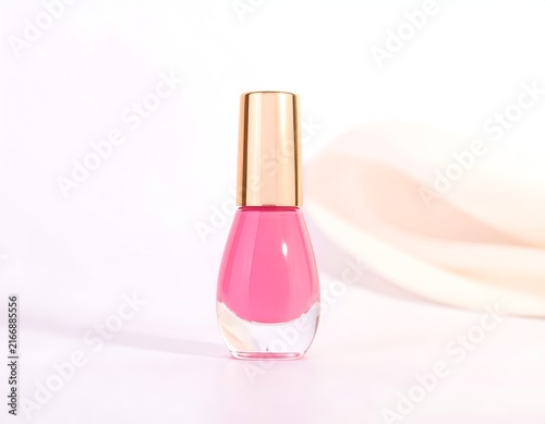 Pink nail polish bottle featuring a metallic gold cap.