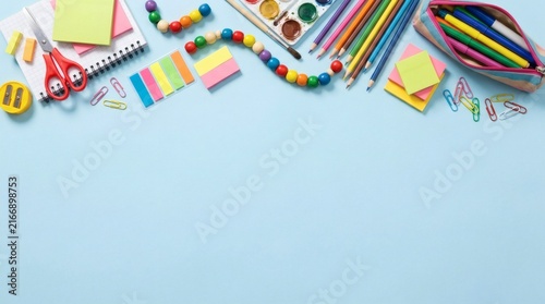 Colorful school supplies arranged on a blue background
